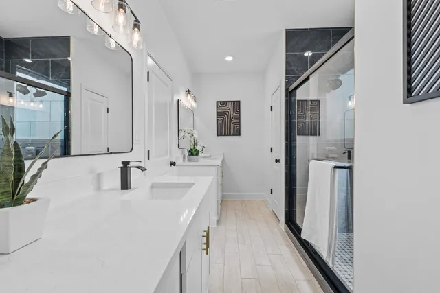 a bathroom with a sink a toilet and shower