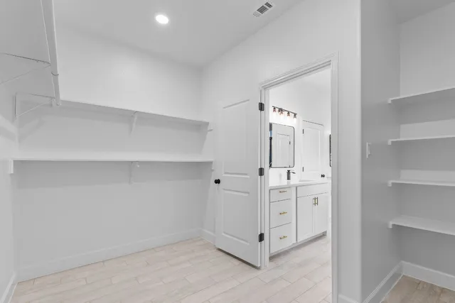 an empty room with a window and a ceiling fan