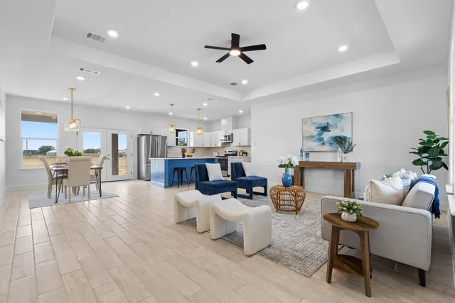 a living room with furniture and kitchen view