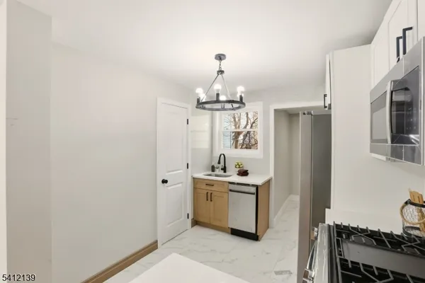 a spacious bathroom with a sink a mirror and a shower