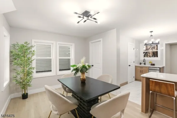a living room with furniture potted plant and windows
