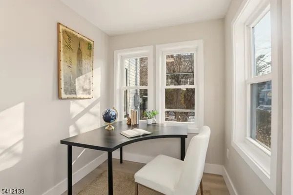 a dining room with furniture and window