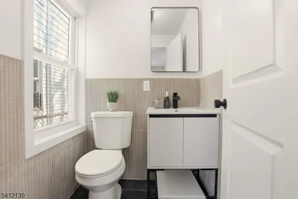 a bathroom with a toilet sink and mirror