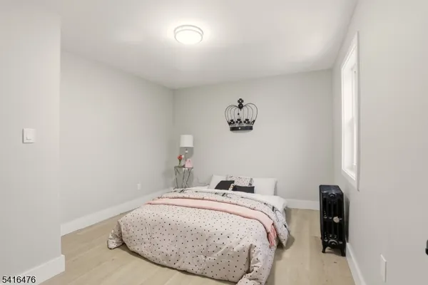 a bedroom with a bed and a wall painting