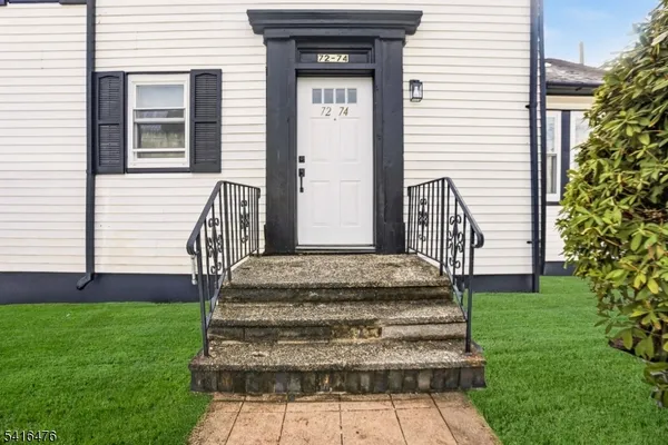 a front view of a house with a garden