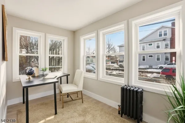 a reading room with furniture and a window