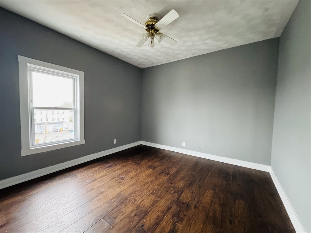 166 Bradford Avenue, Unit 3 Fall River, MA 02721 - Photo 11 of 19 an empty room with a window and a ceiling fan