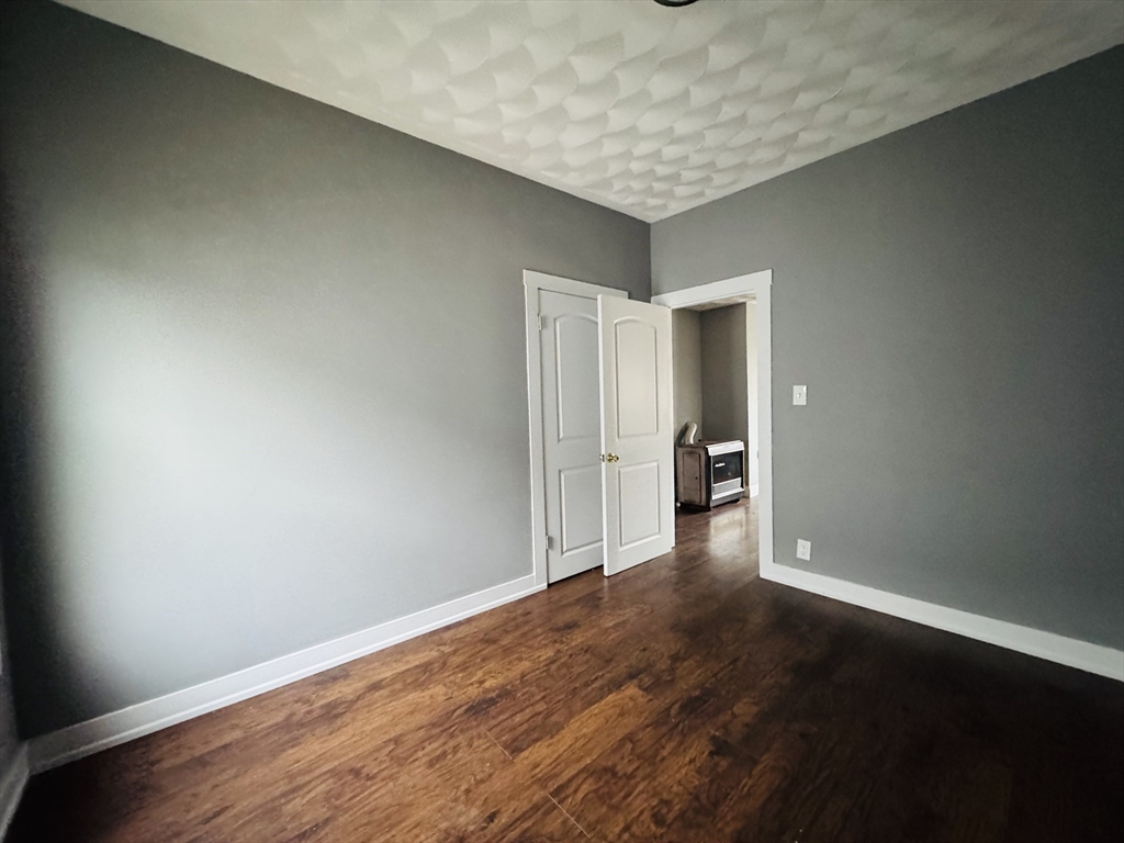 166 Bradford Avenue, Unit 3 Fall River, MA 02721 - Photo 12 of 19 a view of an empty room with wooden floor and closet