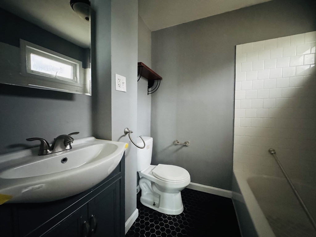 166 Bradford Avenue, Unit 3 Fall River, MA 02721 - Photo 14 of 19 a bathroom with a sink toilet and a mirror