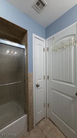 a bathroom with a shower and a sink