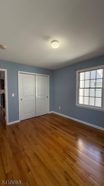 159 Lafayette Street, Unit 3 Newark, NJ 07105 - Photo 16 of 17 a view of an empty room with wooden floor and a window
