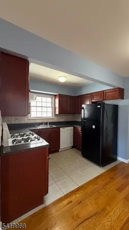 a kitchen with stainless steel appliances granite countertop a refrigerator and a stove
