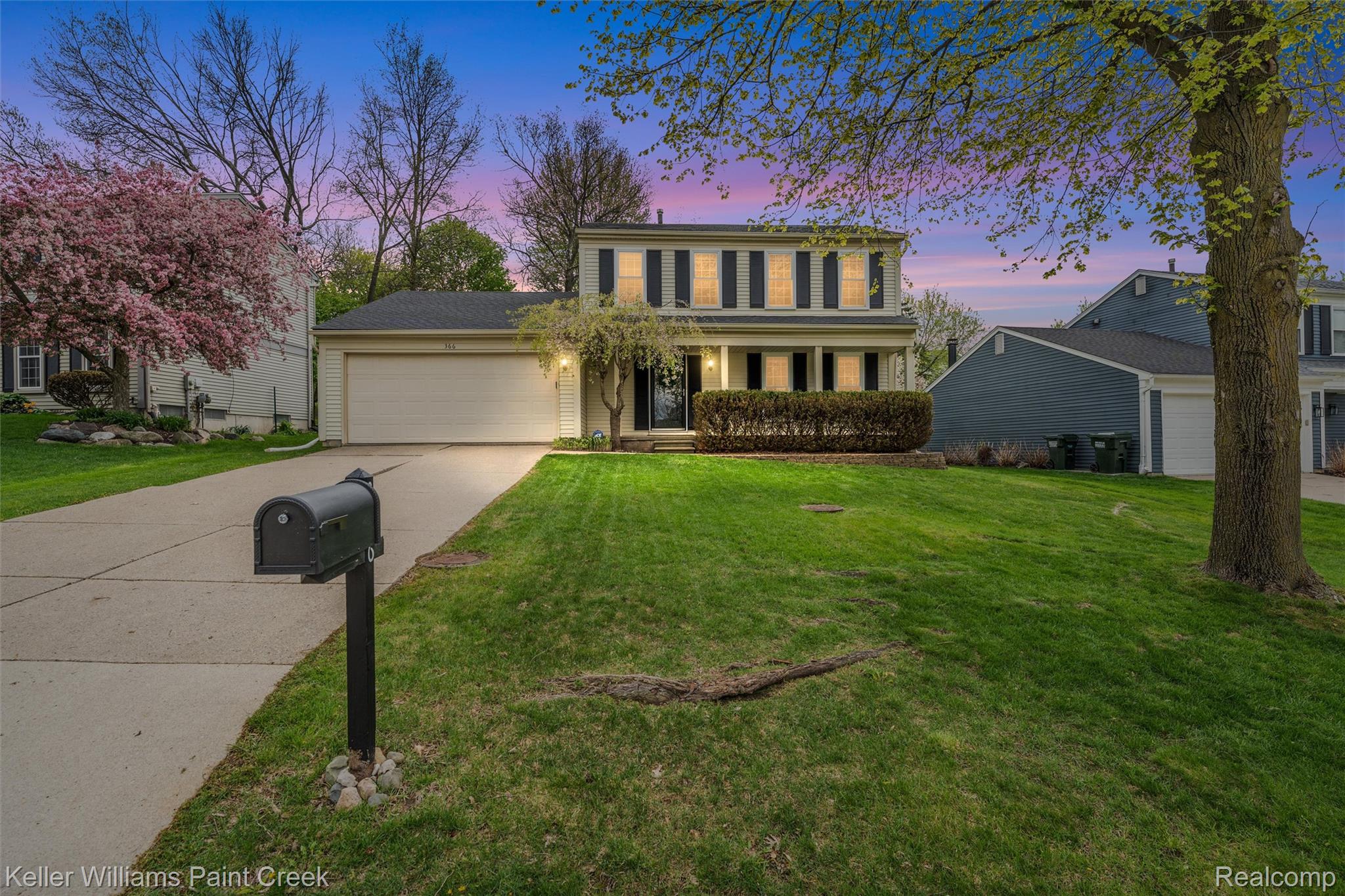 366 Whitney Drive Rochester, MI 48307 - Photo 1 of 44 Colonial inspired home with covered porch, concrete driveway, a garage, and a front lawn