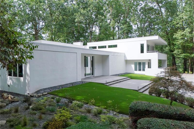 a view of house with backyard and garden