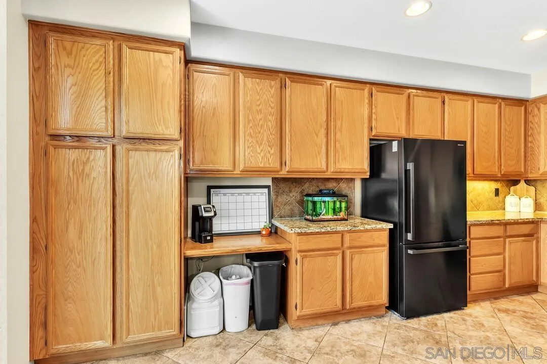 4460 Cloudywing Road Hemet, CA 92545 - Photo 12 of 41 a kitchen with stainless steel appliances granite countertop a refrigerator and a sink