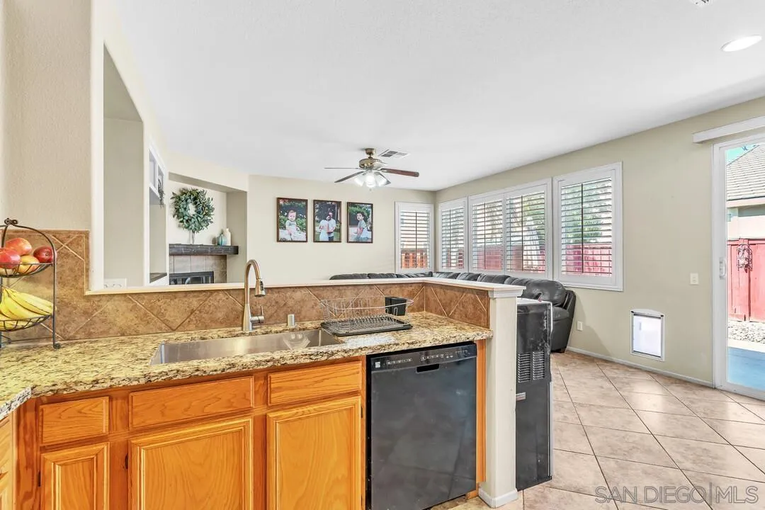 4460 Cloudywing Road Hemet, CA 92545 - Photo 15 of 41 a kitchen with granite countertop a sink and a granite counter tops