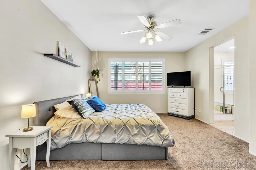 4460 Cloudywing Road Hemet, CA 92545 - Photo 16 of 41 a bedroom with a bed and a flat screen tv