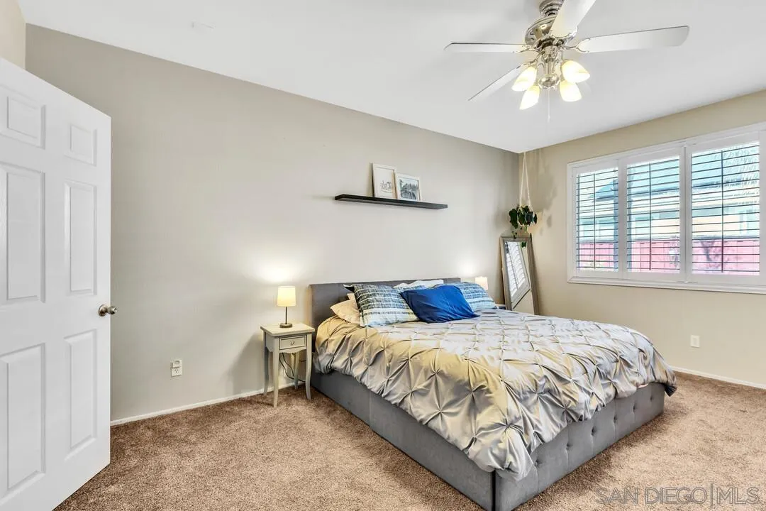4460 Cloudywing Road Hemet, CA 92545 - Photo 17 of 41 a bedroom with a bed and a chandelier