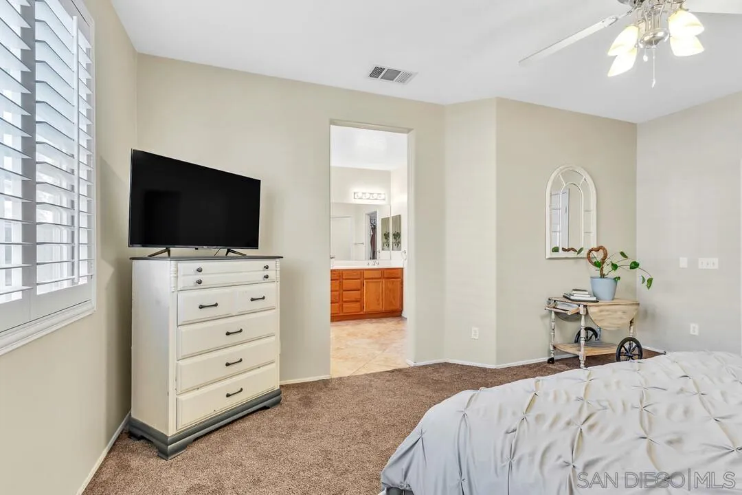 4460 Cloudywing Road Hemet, CA 92545 - Photo 18 of 41 a bedroom with a bed and flat screen tv
