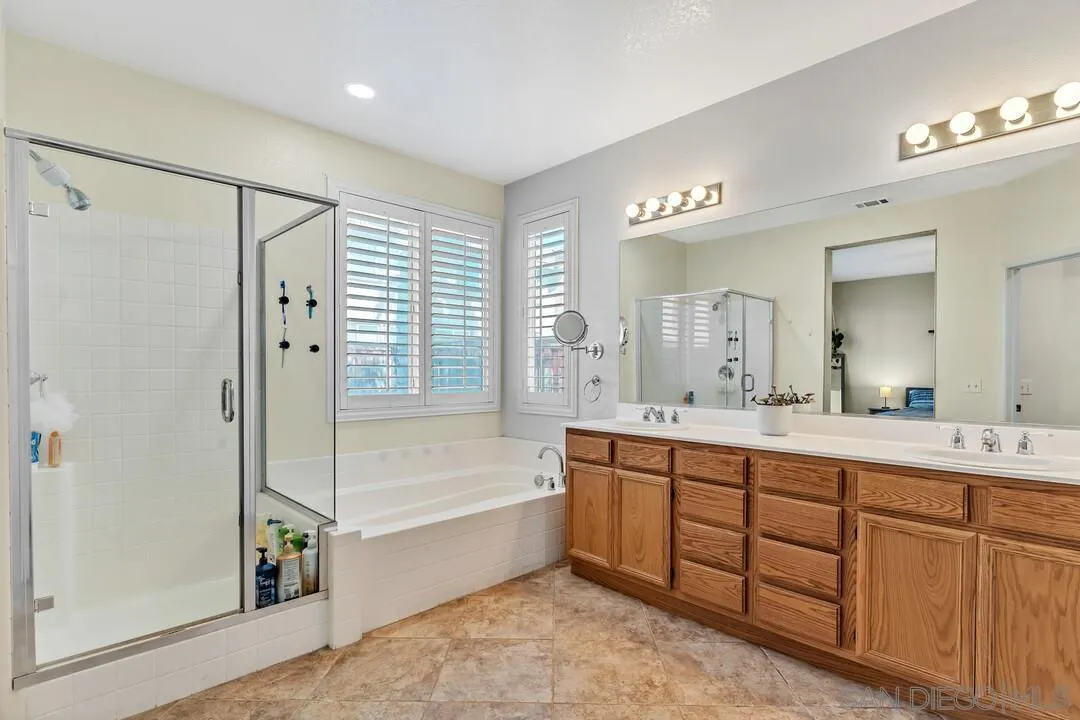4460 Cloudywing Road Hemet, CA 92545 - Photo 20 of 41 a spacious bathroom with a tub sink shower and mirror