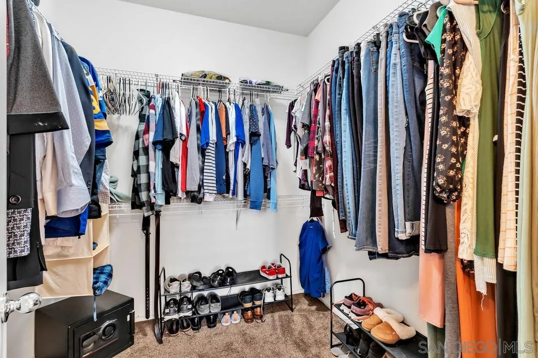 4460 Cloudywing Road Hemet, CA 92545 - Photo 21 of 41 a view of walk in closet with clothes and shoes