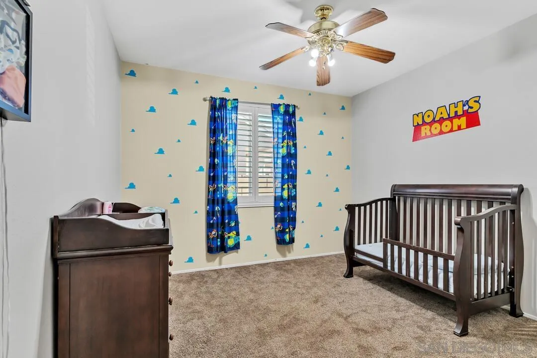 4460 Cloudywing Road Hemet, CA 92545 - Photo 24 of 41 a bedroom with furniture and a chandelier fan