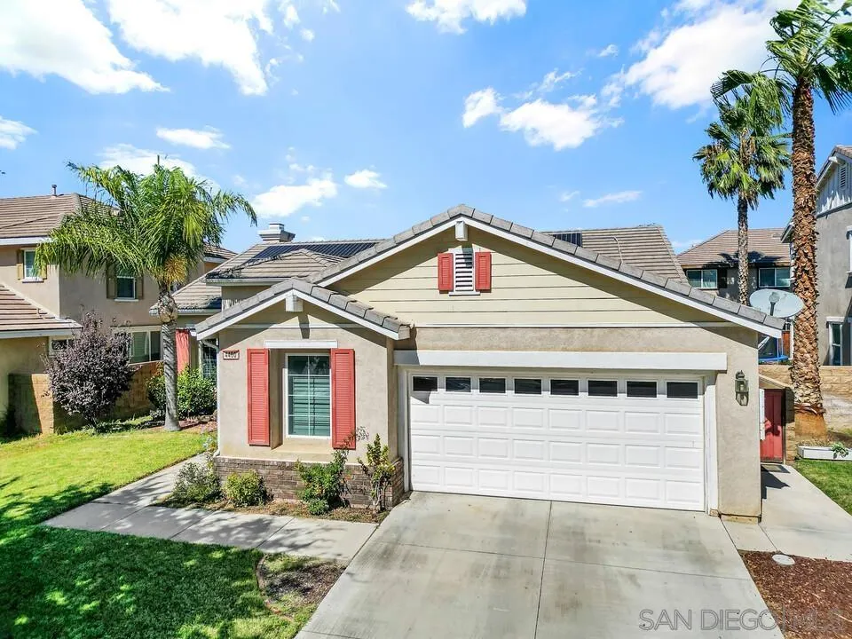 4460 Cloudywing Road Hemet, CA 92545 - Photo 36 of 41 a view of a white house with large windows and a small yard