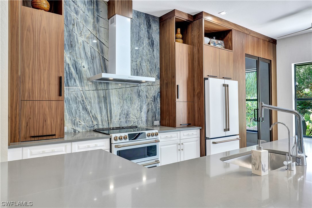 13772 Luna Drive Naples, FL 34109 - Photo 1 of 34 a kitchen with stainless steel appliances a stove and a refrigerator