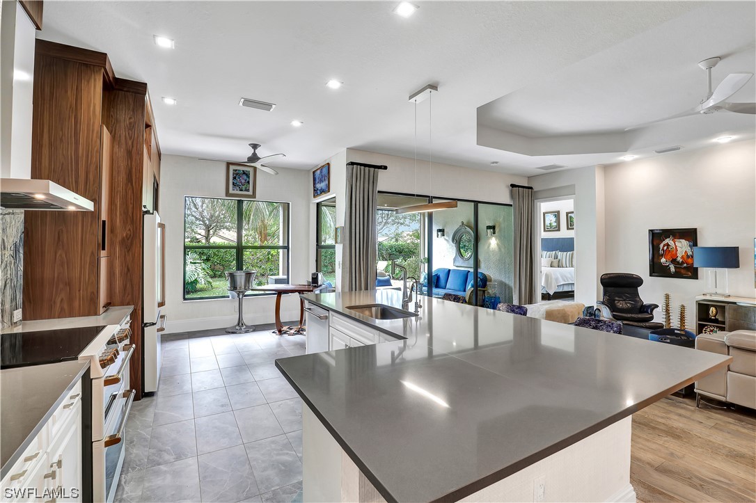 13772 Luna Drive Naples, FL 34109 - Photo 11 of 34 a living room with fireplace furniture and a large window