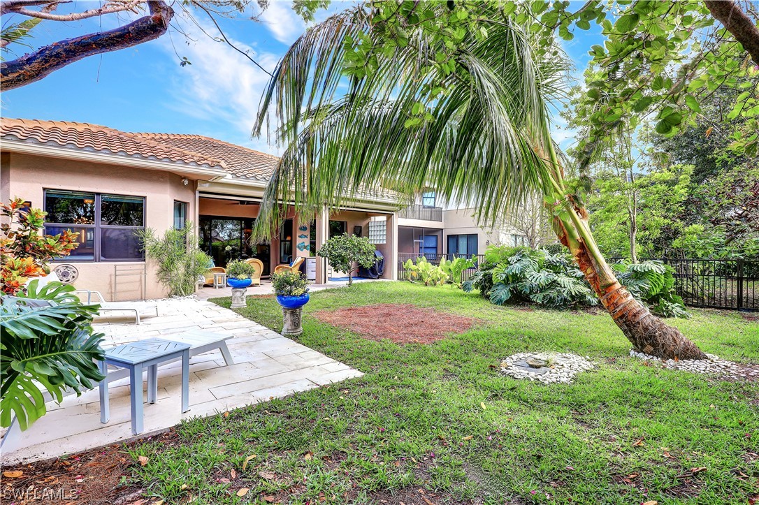 13772 Luna Drive Naples, FL 34109 - Photo 13 of 34 a front view of house with yard and outdoor seating