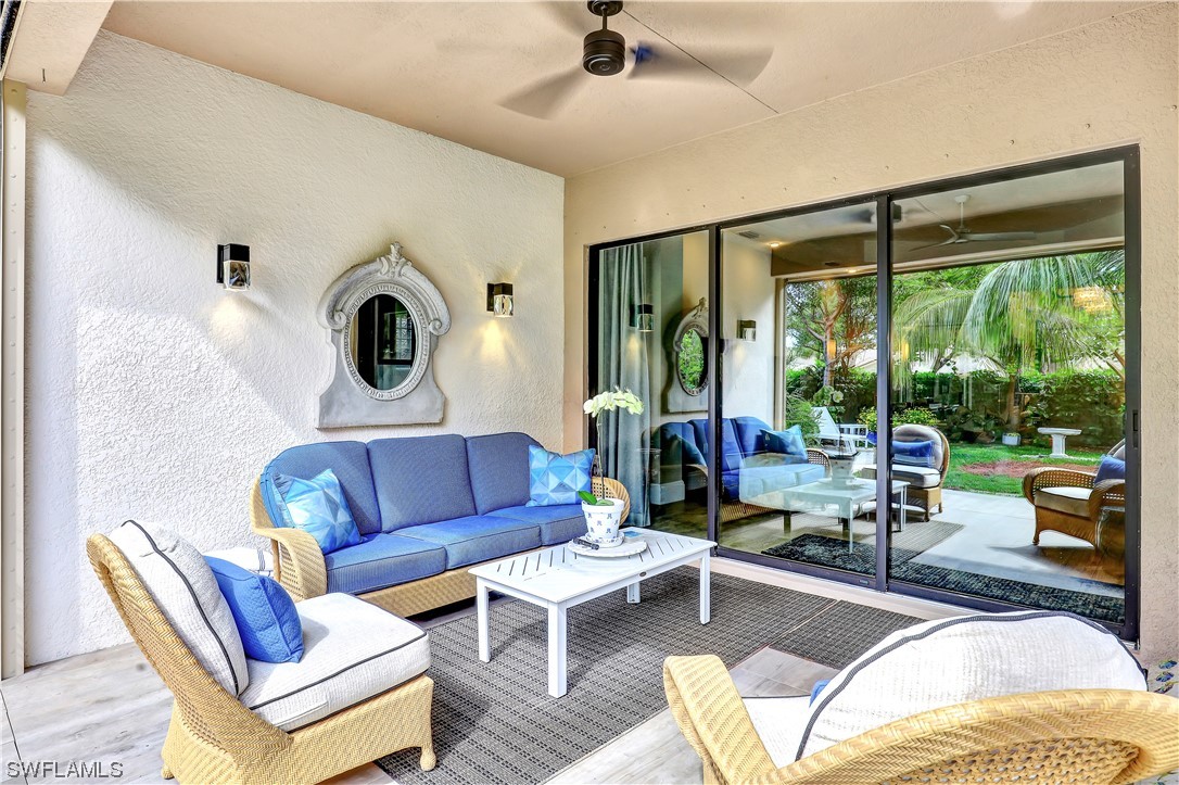 13772 Luna Drive Naples, FL 34109 - Photo 16 of 34 a living room with furniture and a large window