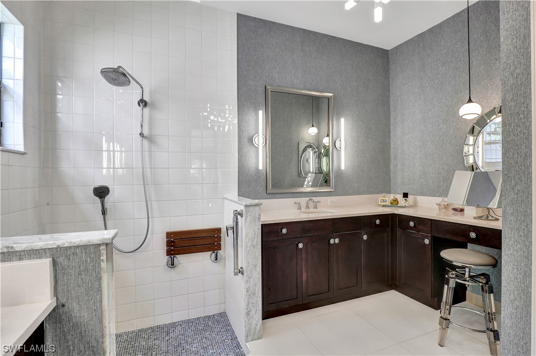 13772 Luna Drive Naples, FL 34109 - Photo 20 of 34 a spacious bathroom with a shower sink and mirror