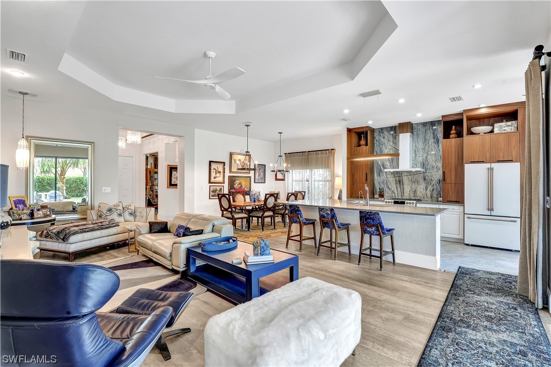 13772 Luna Drive Naples, FL 34109 - Photo 2 of 34 a living room with stainless steel appliances kitchen island granite countertop furniture and a dining table