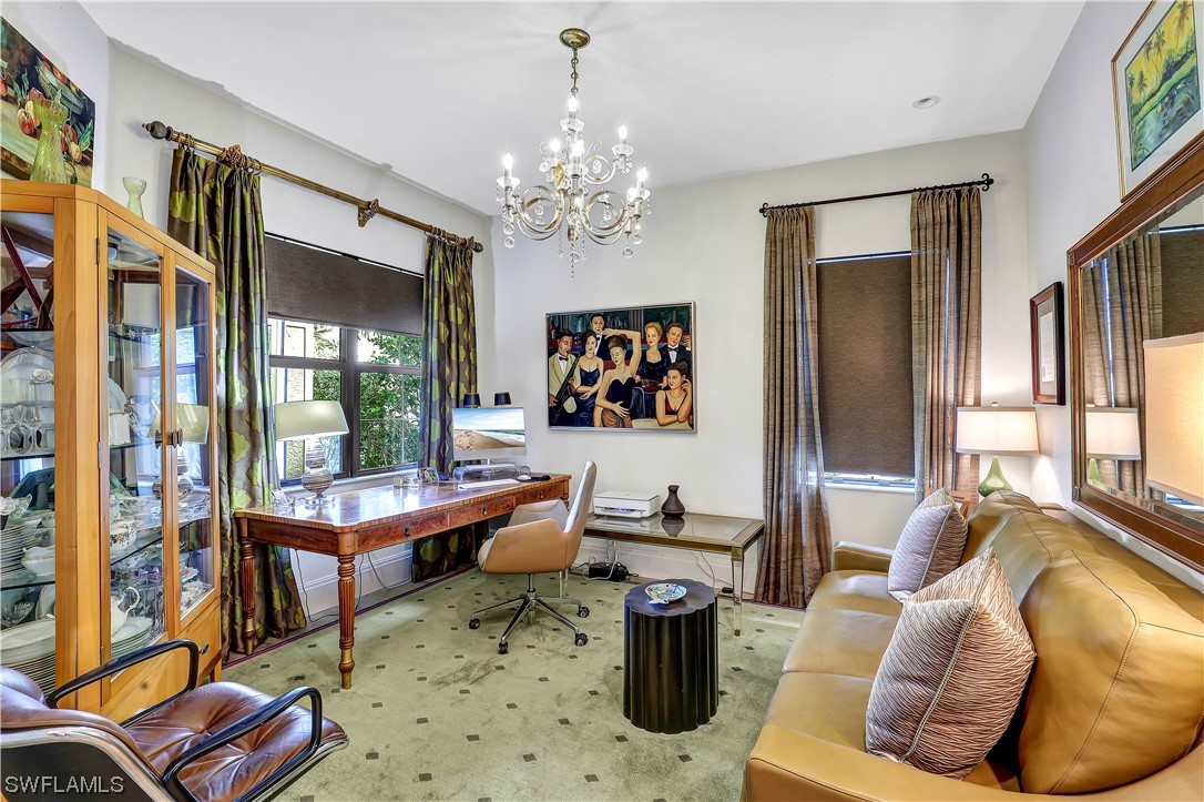 13772 Luna Drive Naples, FL 34109 - Photo 24 of 34 a living room with furniture a chandelier and a large window