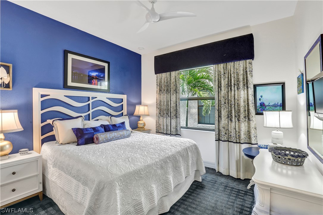 13772 Luna Drive Naples, FL 34109 - Photo 27 of 34 a bedroom with a large bed and a large window