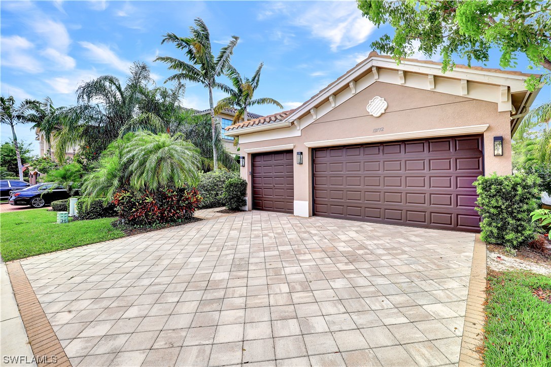 13772 Luna Drive Naples, FL 34109 - Photo 34 of 34 a backyard of a house with plants and palm tree