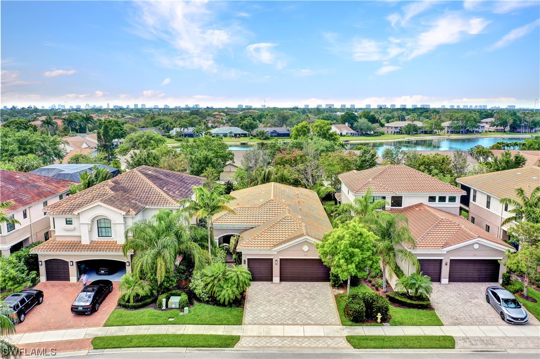 13772 Luna Drive Naples, FL 34109 - Photo 4 of 34 an aerial view of a house with a garden and trees