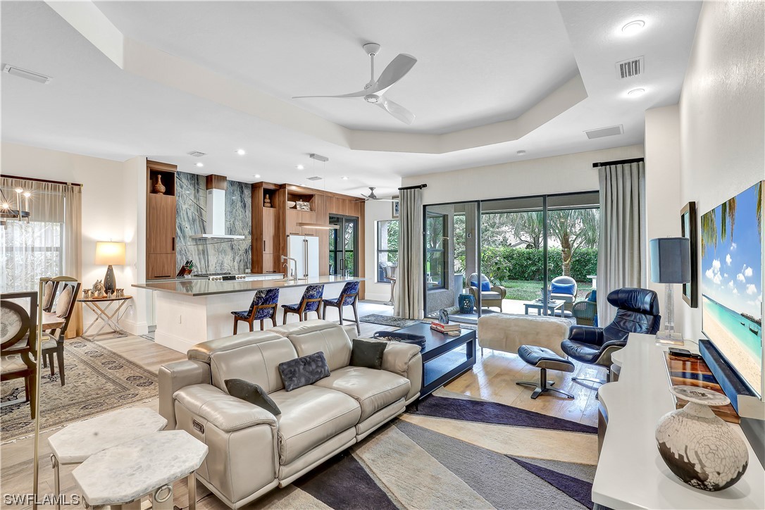 13772 Luna Drive Naples, FL 34109 - Photo 7 of 34 a living room with furniture and a flat screen tv
