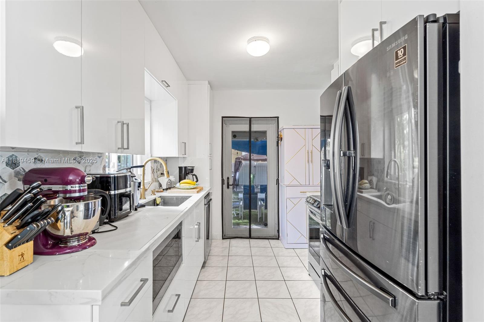 5340 Southwest 5th Street Miami, FL 33134 - Photo 14 of 43 a kitchen with a refrigerator and a sink