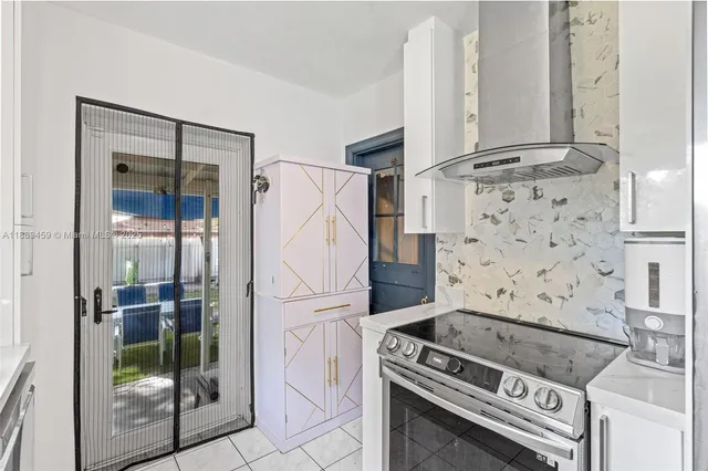 a kitchen with a stove and a refrigerator