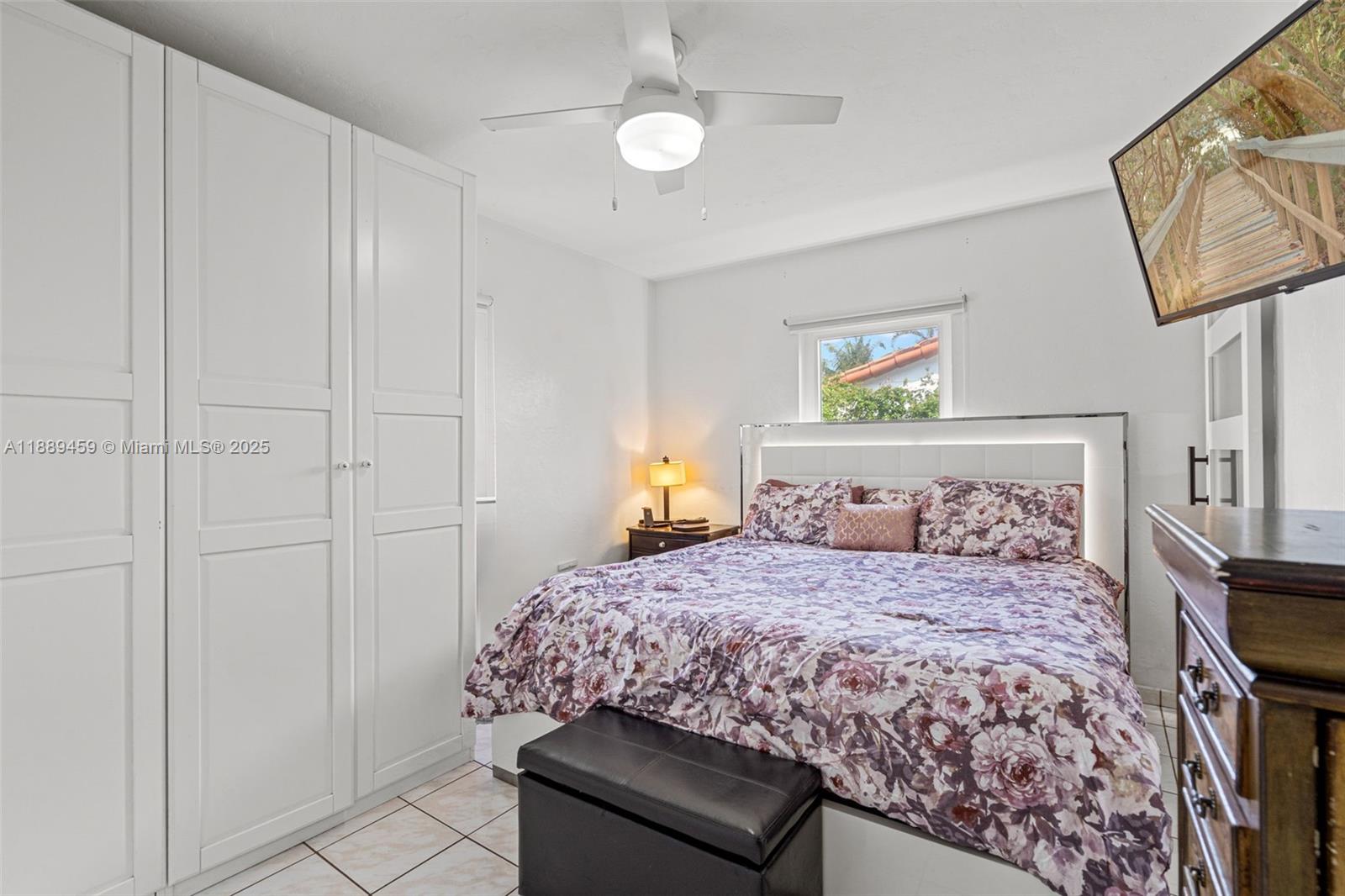 5340 Southwest 5th Street Miami, FL 33134 - Photo 21 of 43 a bedroom with a bed and a chandelier