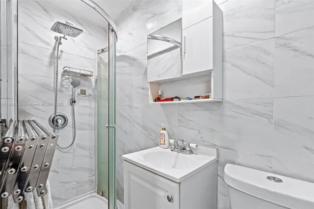 a bathroom with a sink toilet and shower