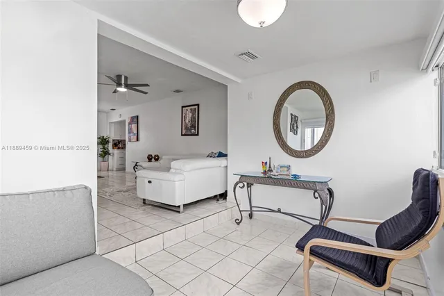 a living room with furniture and a mirror
