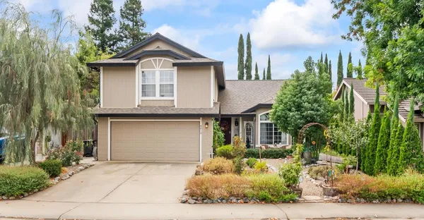 a front view of a house with a yard and garage