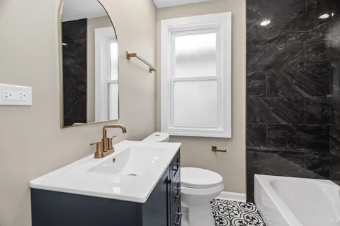 a bathroom with a sink toilet and shower