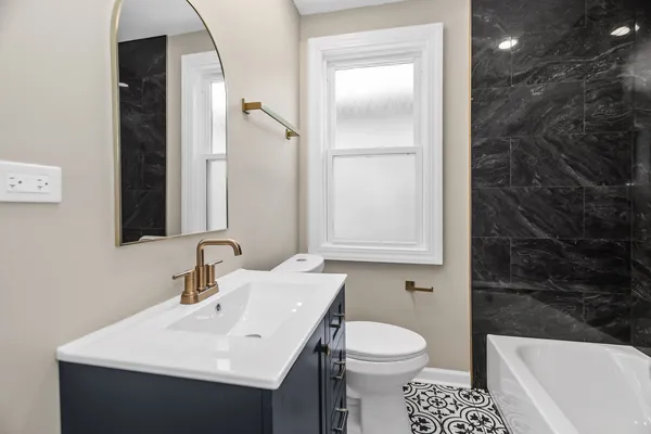 a bathroom with a sink toilet and shower