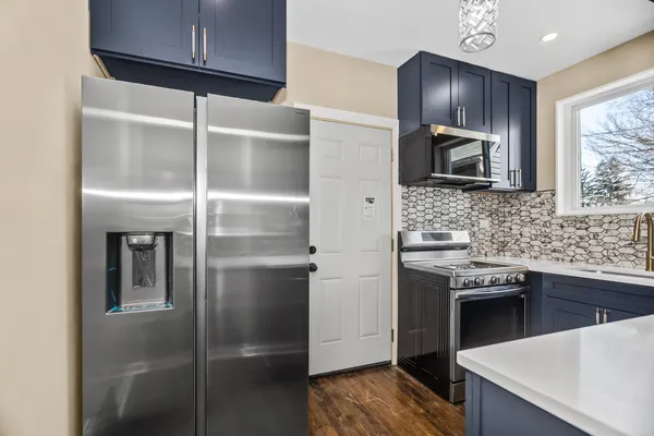 a kitchen with stainless steel appliances cabinets a sink and a counter top space
