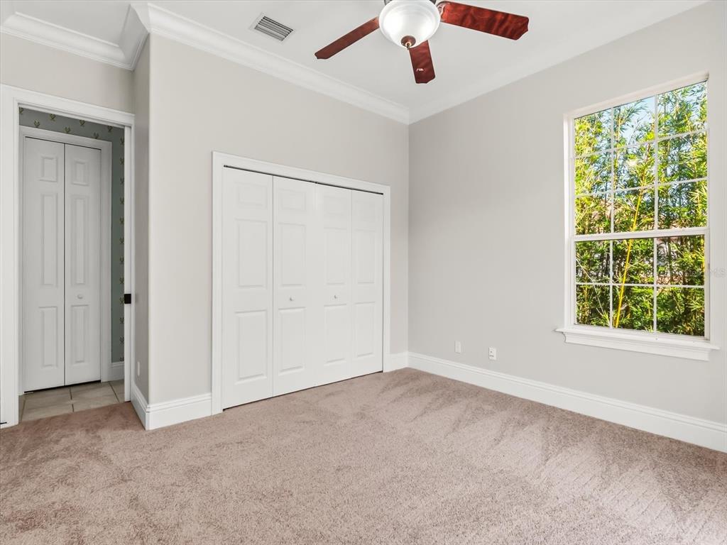 1554 Corolla Court Reunion, FL 34747 - Photo 22 of 71 an empty room with a window and a ceiling fan