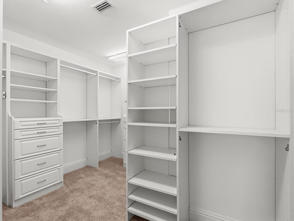 1554 Corolla Court Reunion, FL 34747 - Photo 25 of 75 a view of walk in closet with empty racks