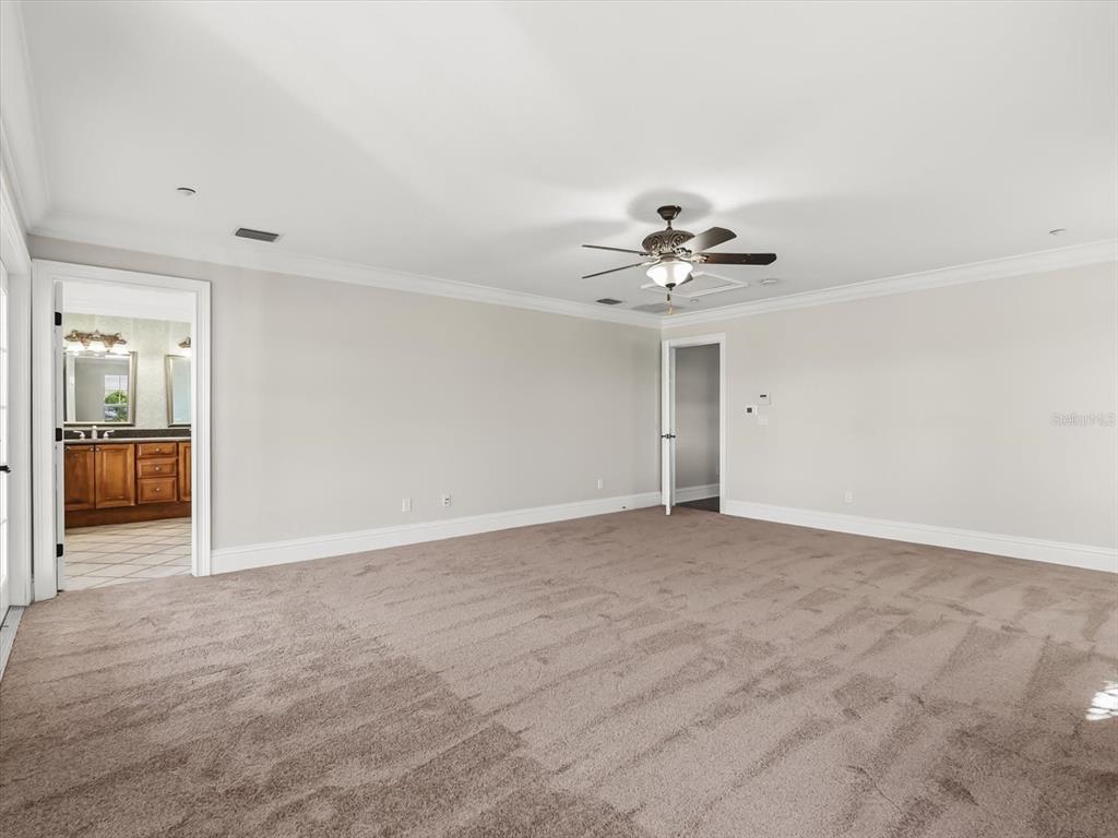 1554 Corolla Court Reunion, FL 34747 - Photo 31 of 75 a view of an empty room with a ceiling fan